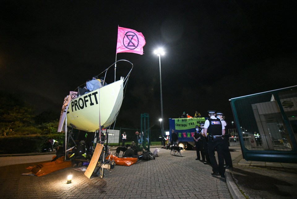 XR demonstrators used a boat to block the road near a printing press