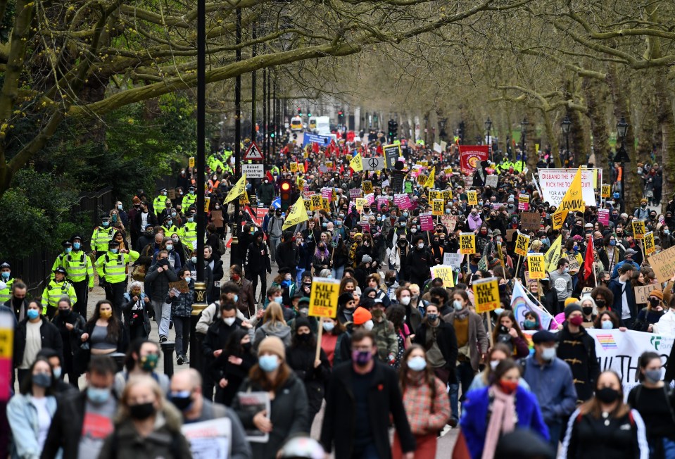 Hundreds of people walking through Hyde Park as they protest