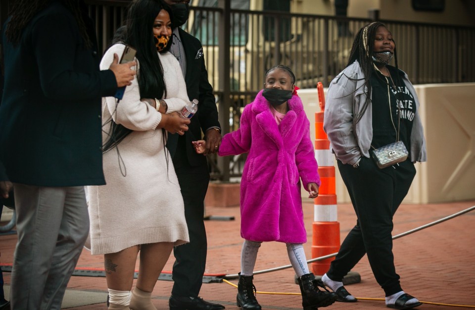 Gianna Floyd, the daughter of George Floyd, walks towards the entrance of the the courthouse with her family