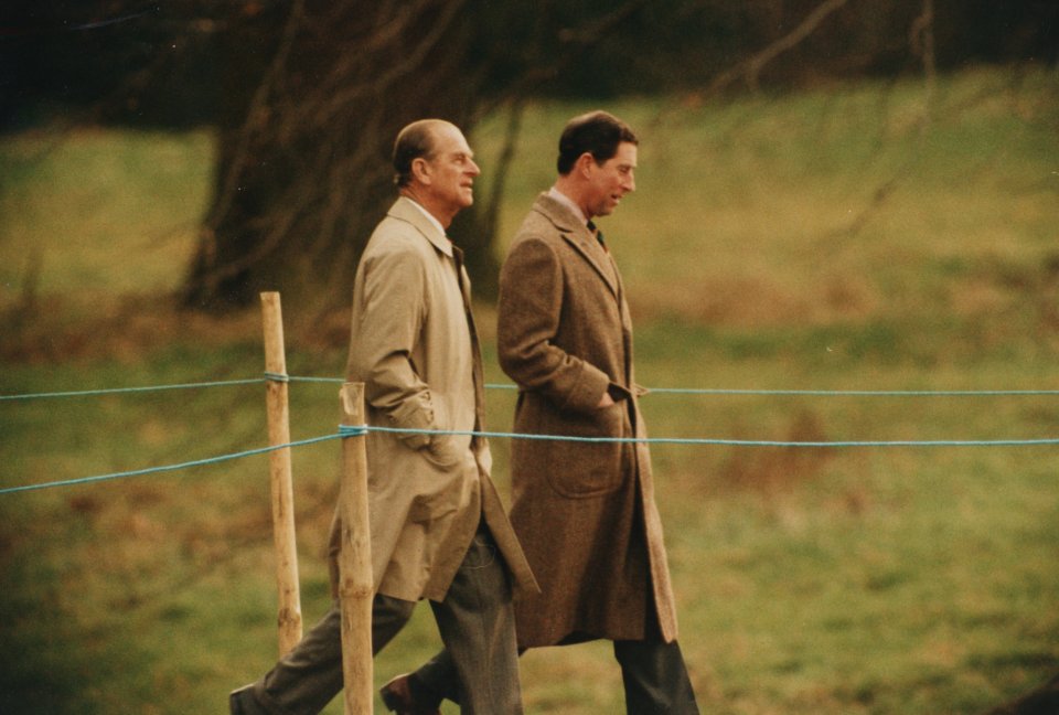 Prince Charles walking with his father Prince Philip