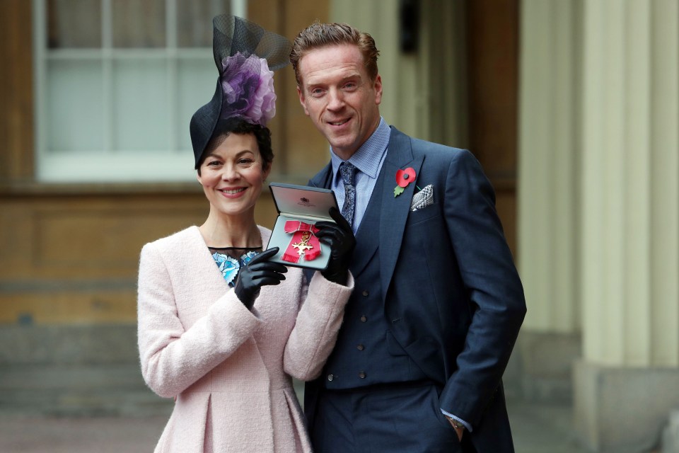 Helen McCrory holds up her OBE with husband Damian Lewis in 2017