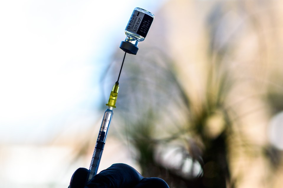 A health worked prepares a syringe with the Pfizer vaccine in Germany