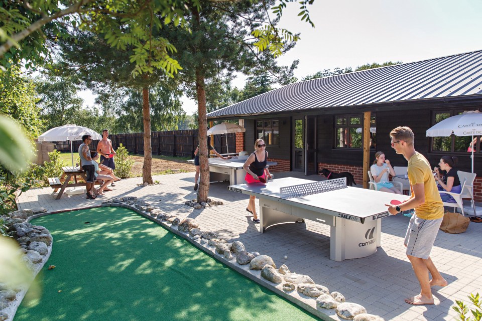 The Basecamp at Clippesby Hall has a stylish bar, well-stocked mini-market, ping-pong table and mini golf