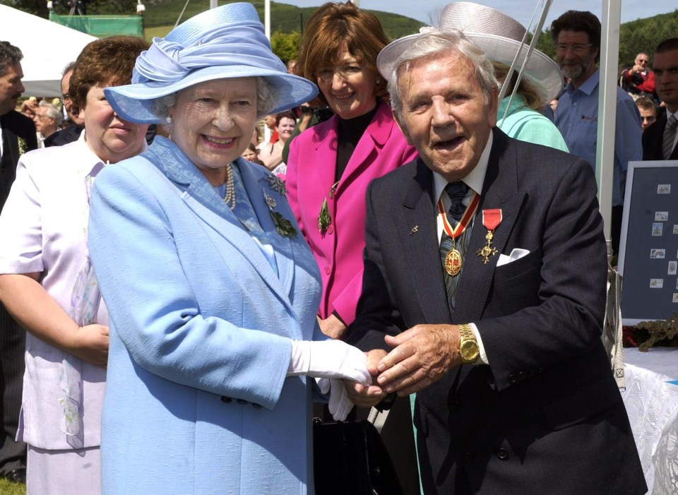 Sir Norman Wisdom ignored royal protocol in July 2003 when he jumped out of the line-up and grabbed the Queen’s hand