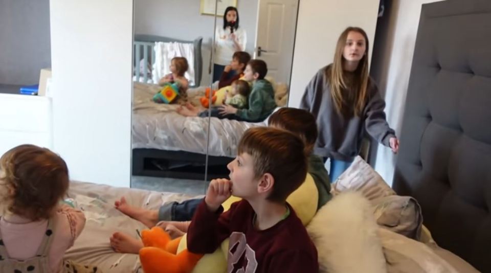 The kids were shown in the vlog crowding round the TV