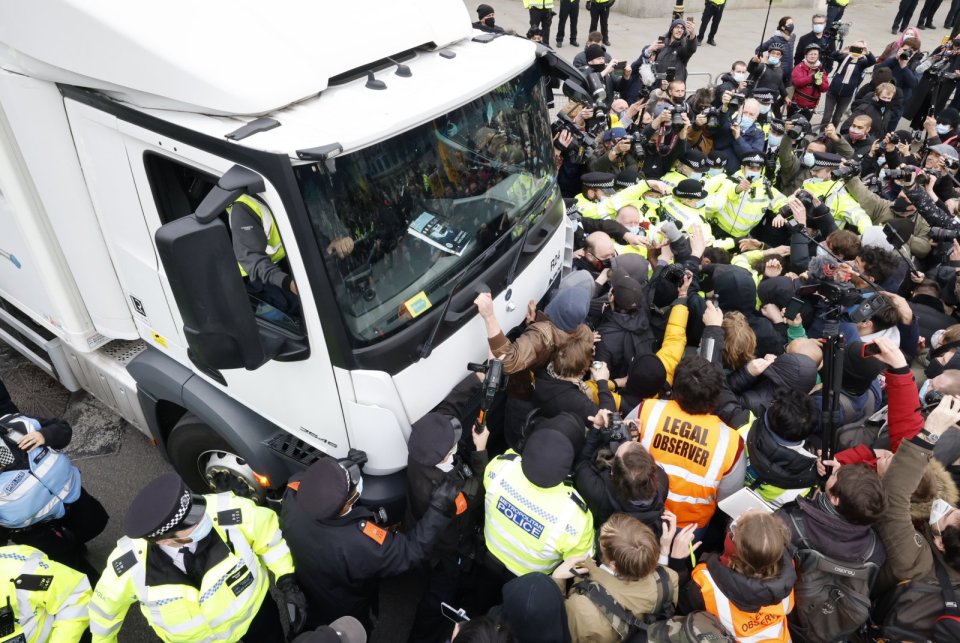 Scuffles have broken out as protesters surrounded a McDonald's truck in Parliament Square