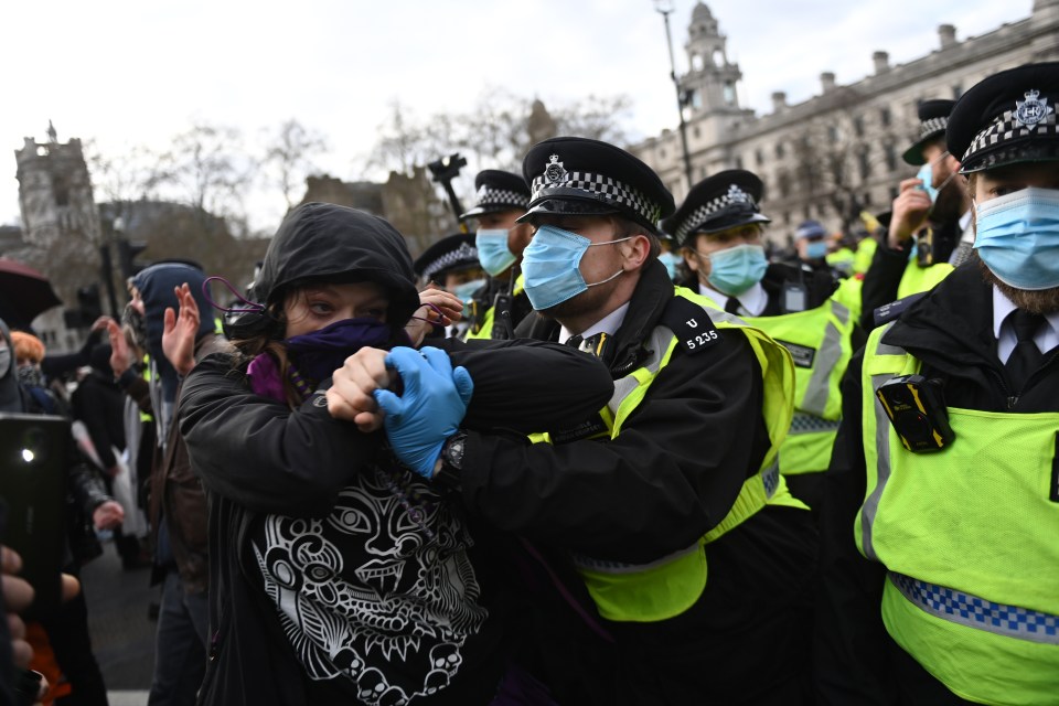 Police detain a protester during a 'Kill the Bill' protest in London