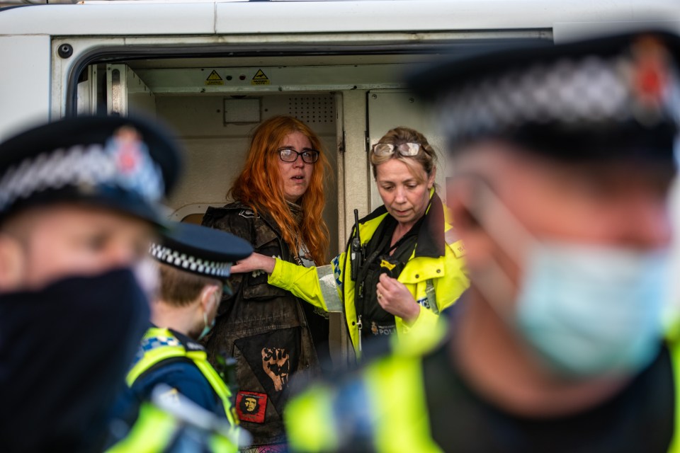 Police take a woman into custody