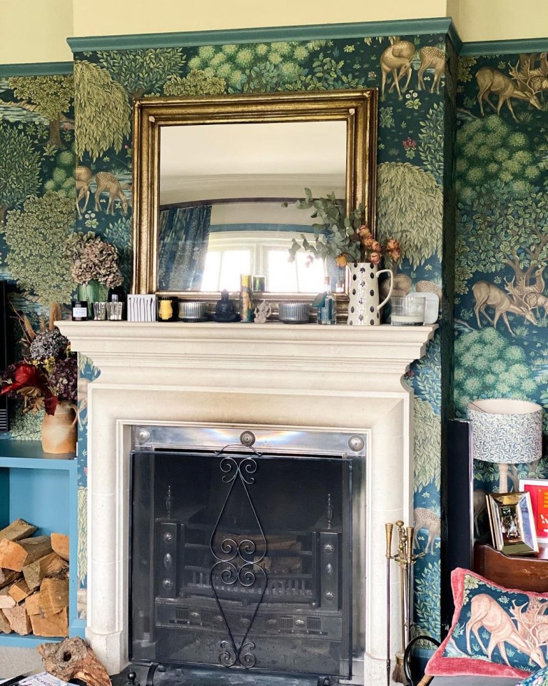 The marble fireplace and gold mirror take centre stage in the living room