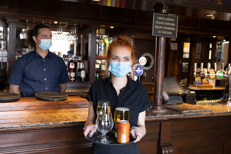 Khan Moore prepares the drinks for Hannah Anderson-Moore to deliver to the customer