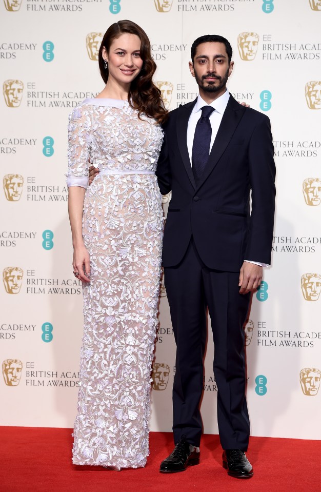 Olga Kurylenko and Riz Ahmed pose in the winners room at the 2016 Baftas