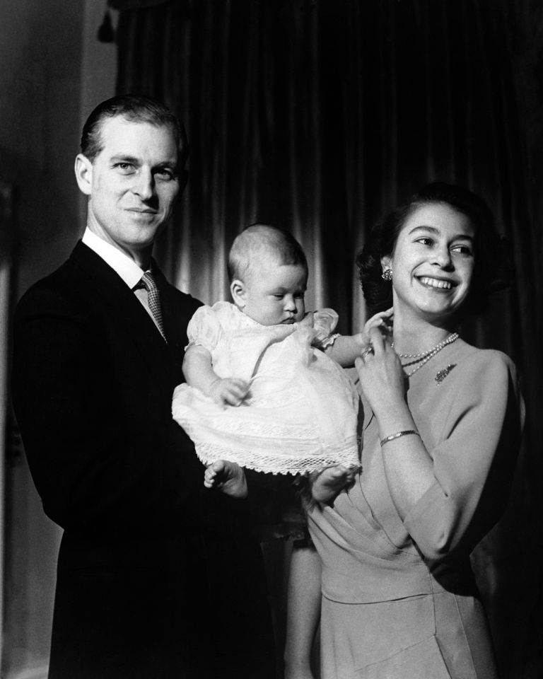 Queen Elizabeth II and the Duke of Edinburgh holding their first child Prince Charles, aged six months