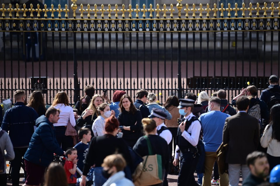 Members of the public gather outside Buckingham Palace to pay tribute to the Duke of Edinburgh