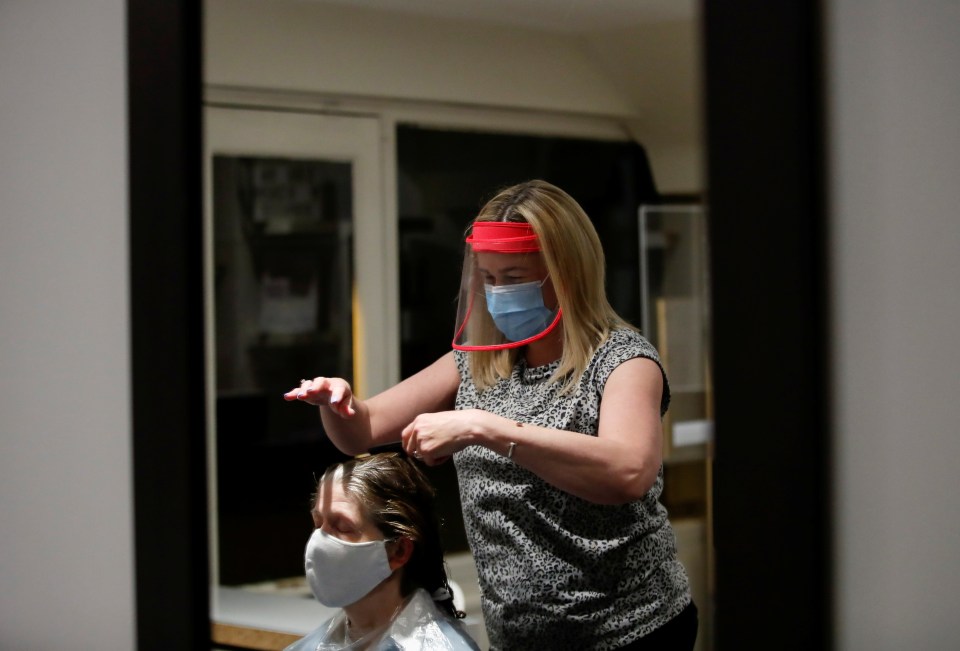 Kelly Boad, owner of Hair & Beauty Gallery, gives Sue Butcher a haircut in Warwick