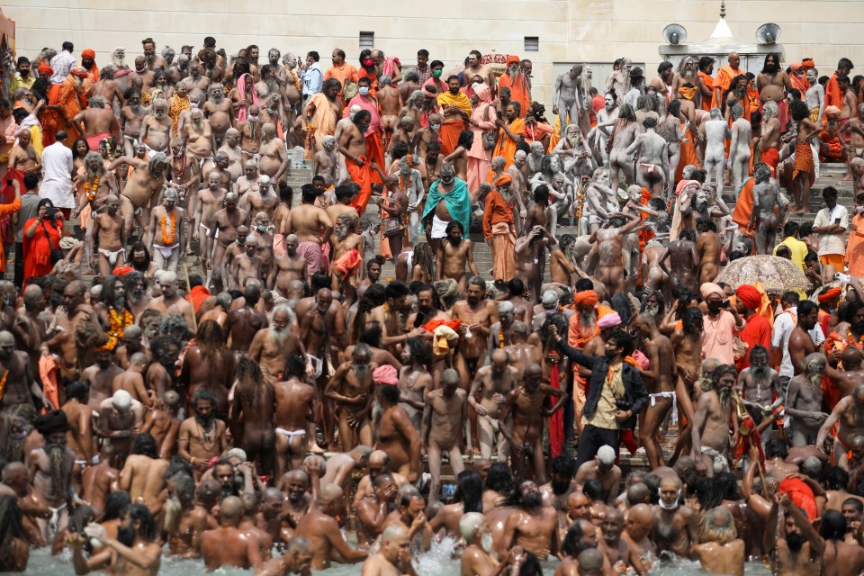 Naga Sadhus, or Hindu holy men, take a dip in the Ganges river during the second Shahi Snan at Kumbh Mela, or the Pitcher Festival, amid the spread of the coronavirus disease