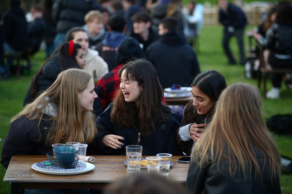 People celebrate being allowed to have a drink in the pub yesterday