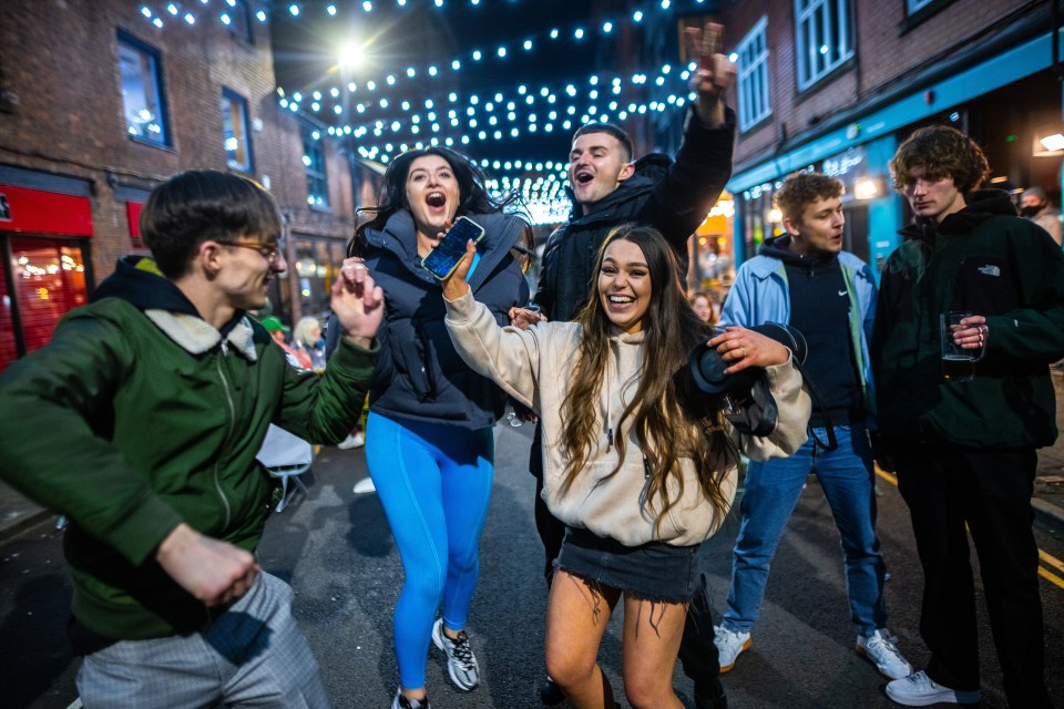 People dance in Manchester as they go out for the first time in months