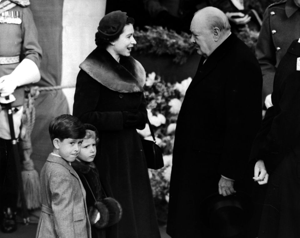 Elizabeth seen talking to Winston Churchill in 1953 as Charles and Anne wait by her side