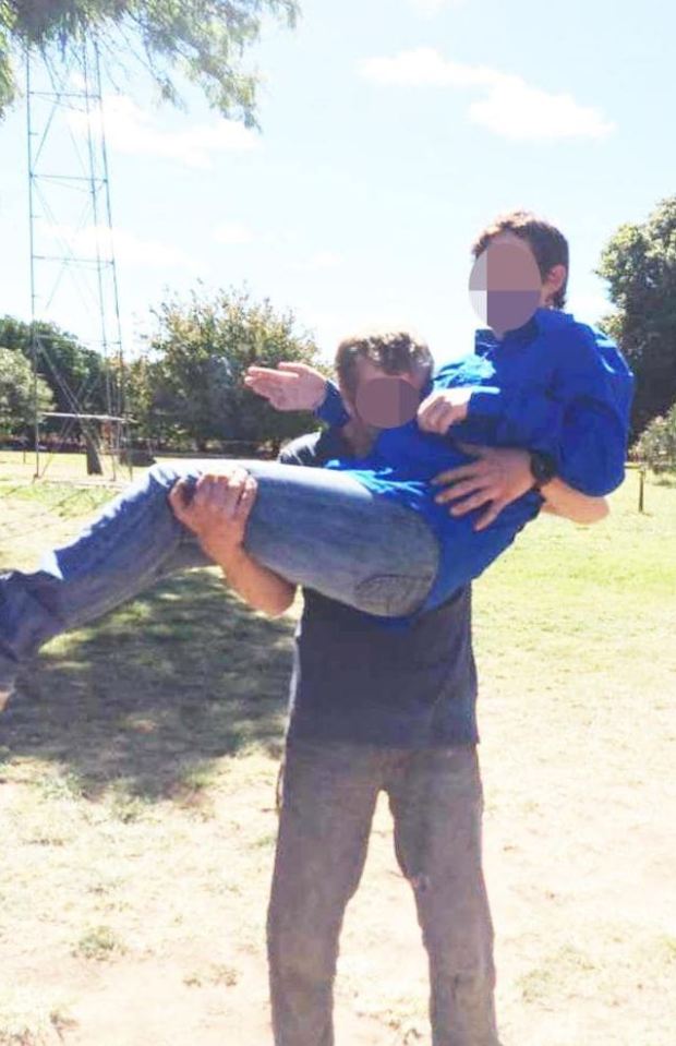 Raylene Colt is lifted up by her brother Joe on a farm