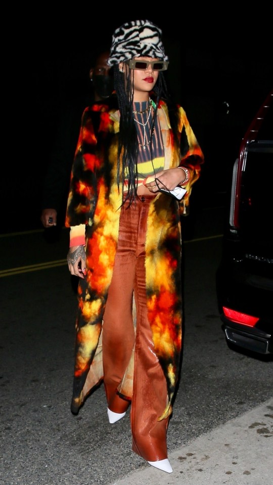 Rihanna sported a tie-dye top with an eye-catching jacket and leather-trimmed trousers