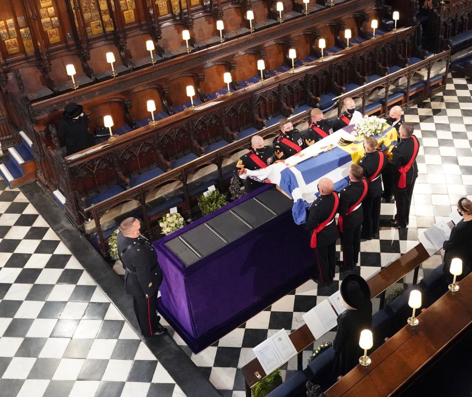 Prince Philip's coffin is lowered onto a plinth in front of the Queen