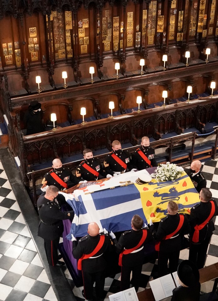 The Queen watches as the coffin is carried into the chapel