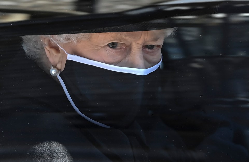 Britain's Queen Elizabeth II followed the coffin in a car as it makes it's way past the Round Tower during the funeral