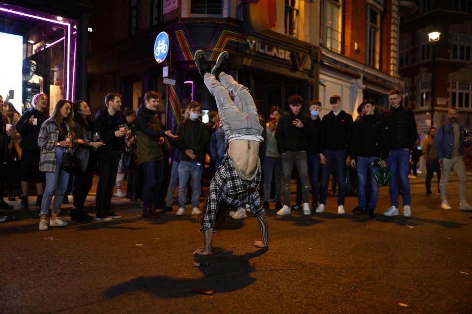 One reveller dances for a crowd in Soho