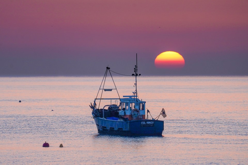 This morning's sunrise by the fishing boats over the English Channel seen from Selsey in West Sussex