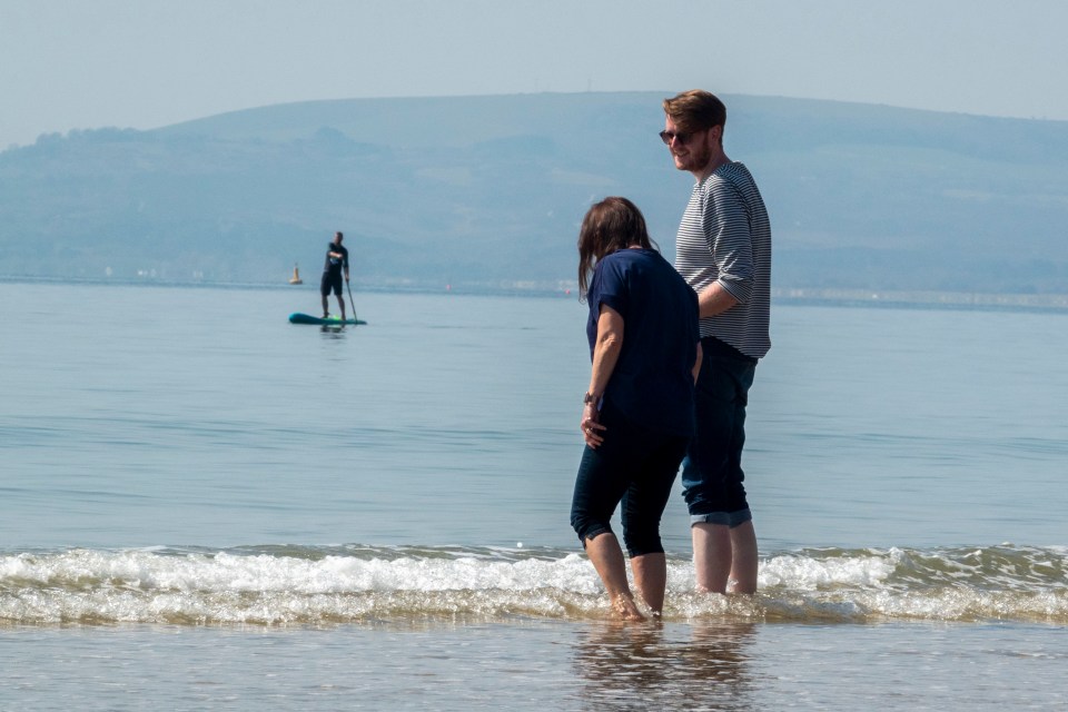 People on Bournemouth beach enjoying the hot weather