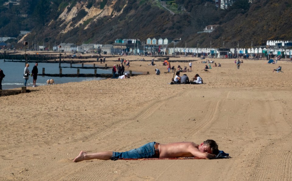 People on Bournemouth beach enjoying the hot weather