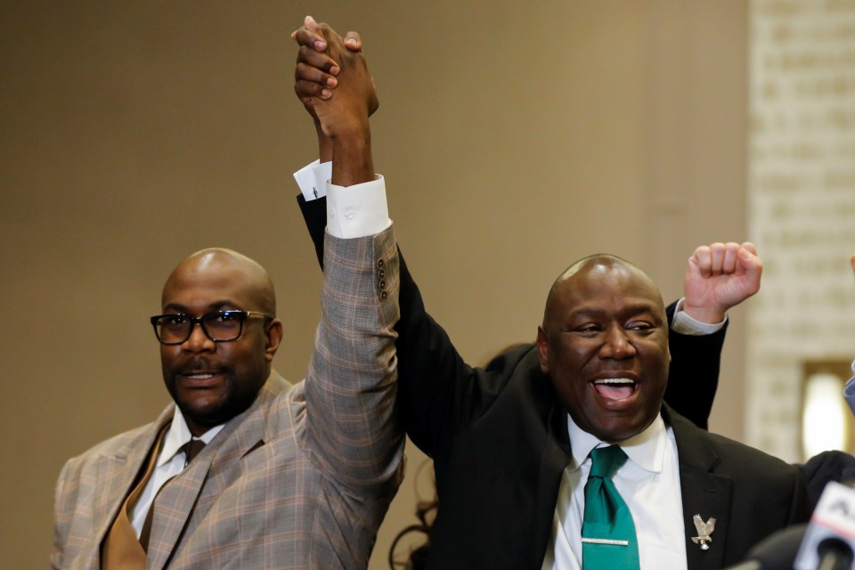 Floyd family attorney Ben Crump and Philonise Floyd raise their fists during a news conference following the verdict