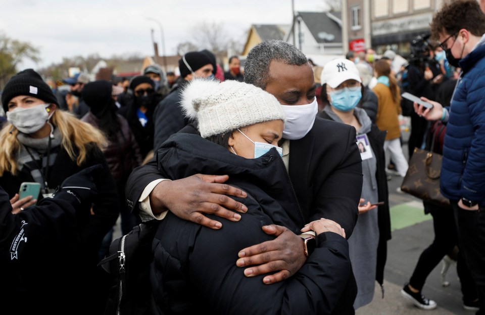 People hug after the verdict in the trial