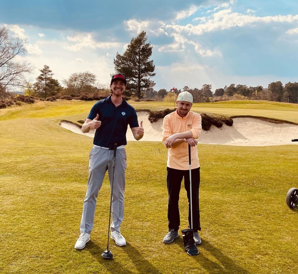 Fans were rather distracted by this image of James Phelps playing golf with Tom Felton