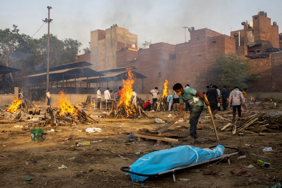 Funeral pyres burning as gravediggers struggle to keep up with the mounting death toll