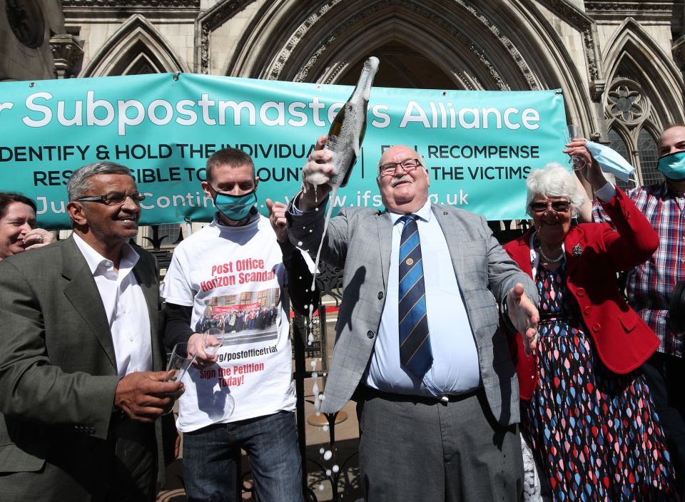 Former post office worker Tom Hedges (centre) pops a bottle champagne in celebration outside the Royal Courts of Justice