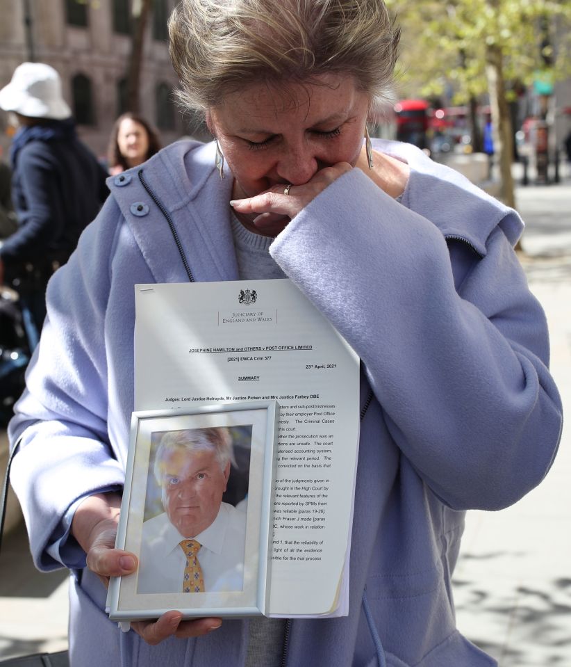 Karen Wilson, widow of postmaster Julian Wilson who died in 2016, holds a photograph of her husband outside the Royal Courts of Justice, London, after his conviction was overturned by the Court of Appeal