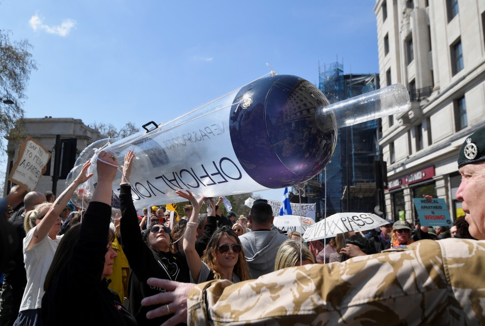 Giant inflatable syringes were carried through the streets