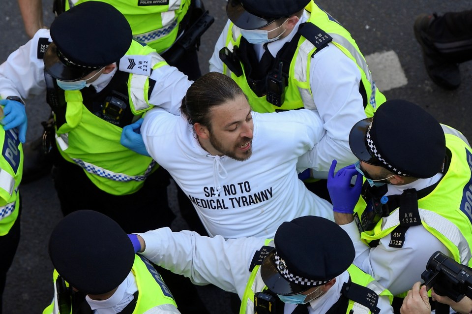 Police detain a demonstrator during the rally