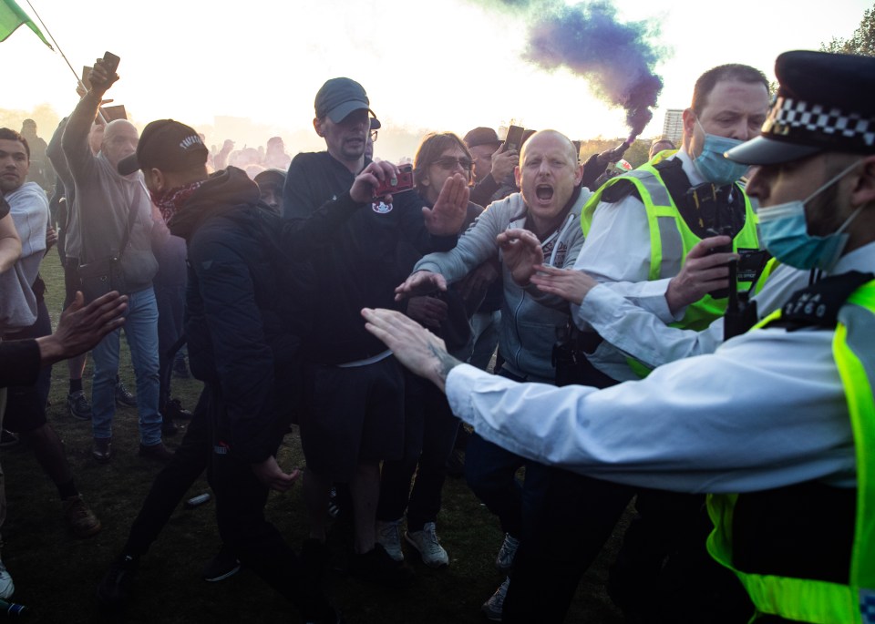 One demonstrator was pictured letting off a blue smoke canister