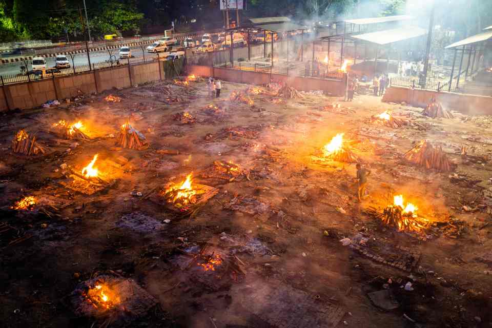 In Delhi the night sky glows orange from funeral pyres