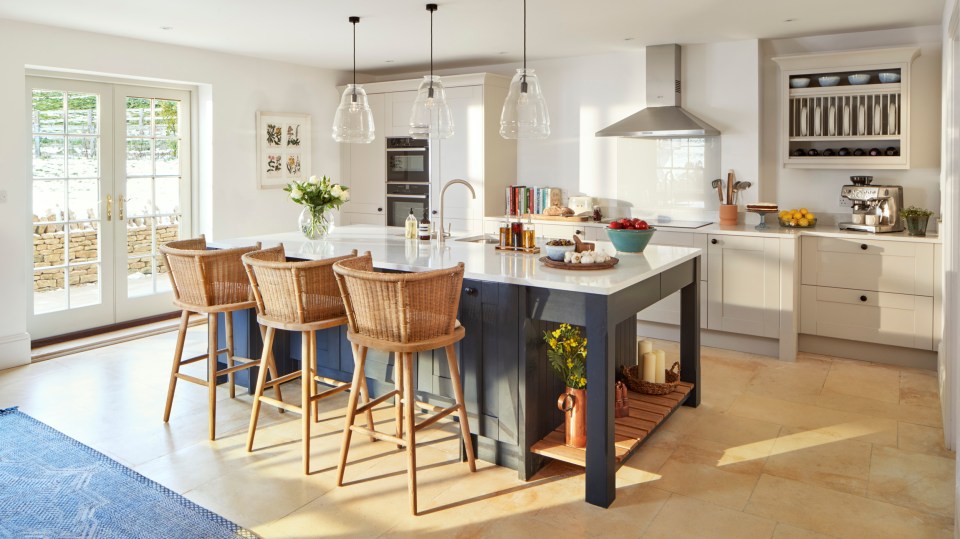 The bright and modern open-plan kitchen leads out to the garden