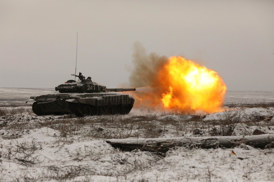 A Russian tank fires as troops take part in drills in southern Russia in January