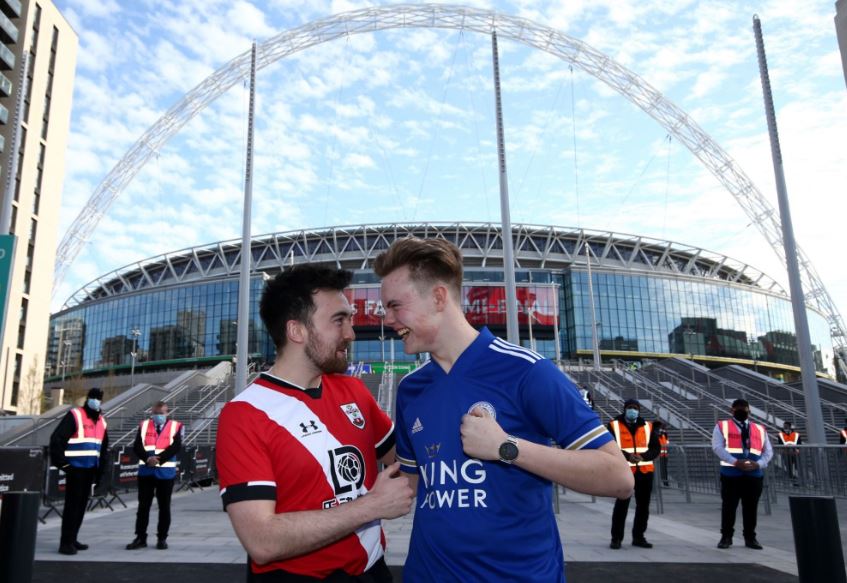 Southampton fan Elliot Jenkins, left, and Leicester City fan Luke Beck share their joy ahead of the FA Cup semi-final as supporters are being allowed back in