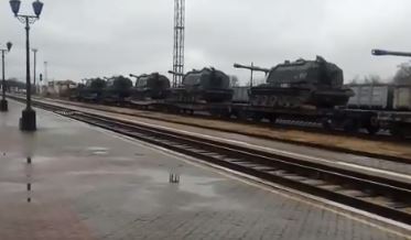 Howitzers are seen stacked on rail cars heading towards the border last week