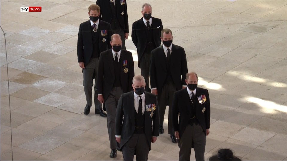 Prince Harry walking into the chapel behind Prince William