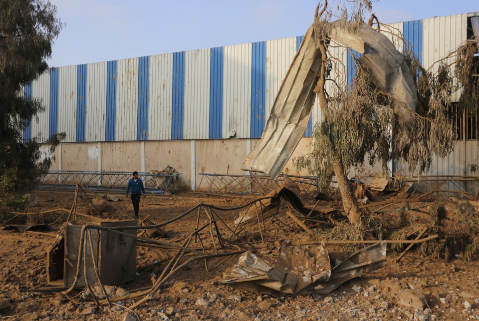 Palestinians inspect the rubbles of a building destroyed by Israeli air strikes in Gaza city