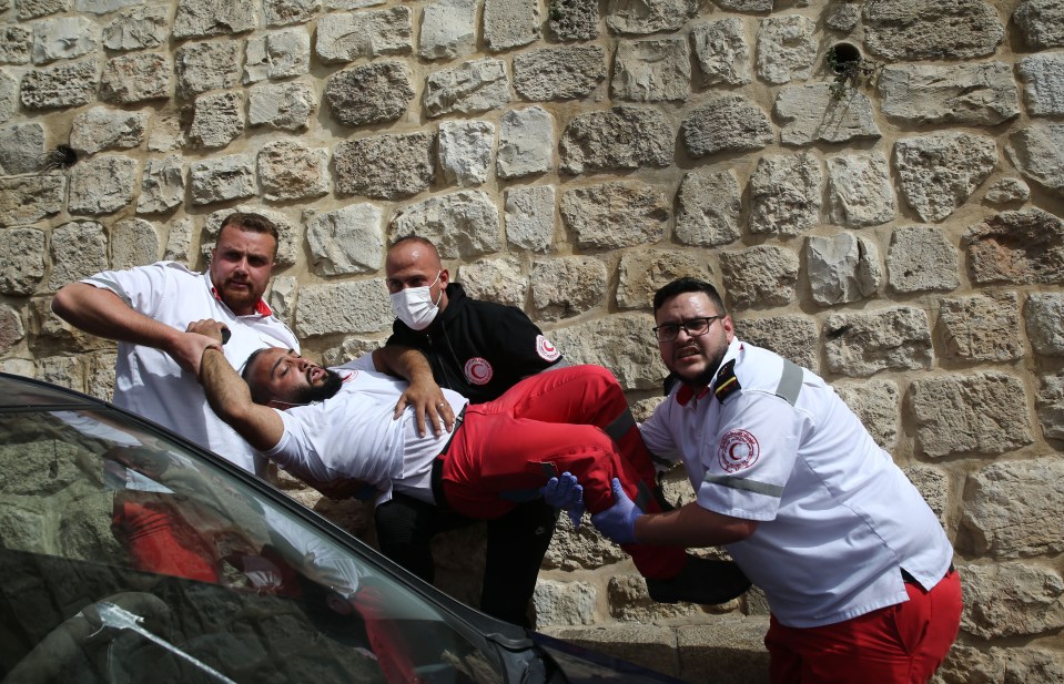 Paramedics help the injured Palestinians