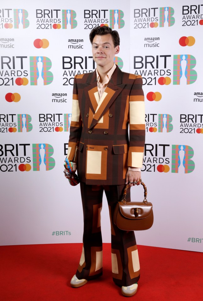 He accessorised the daring look with a brown handbag