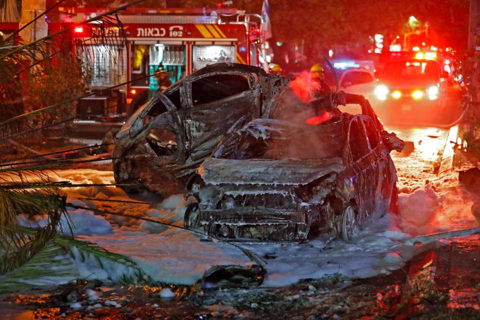 Cars destroyed by rockets are seen in the Israeli town of Holon near Tel Aviv